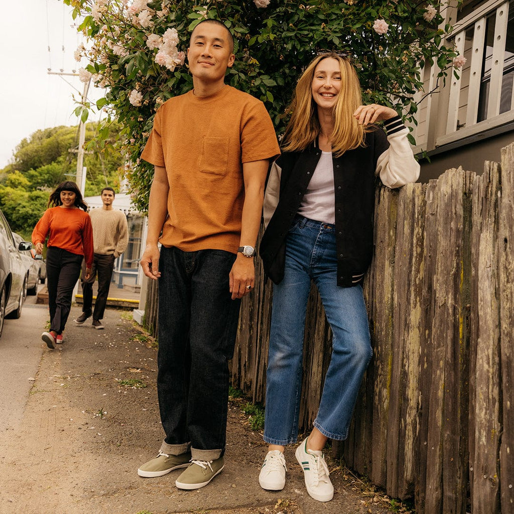 Men's Sixty Six Sneaker in Surplus Green canvas, worn with dark jeans by two people standing on a path