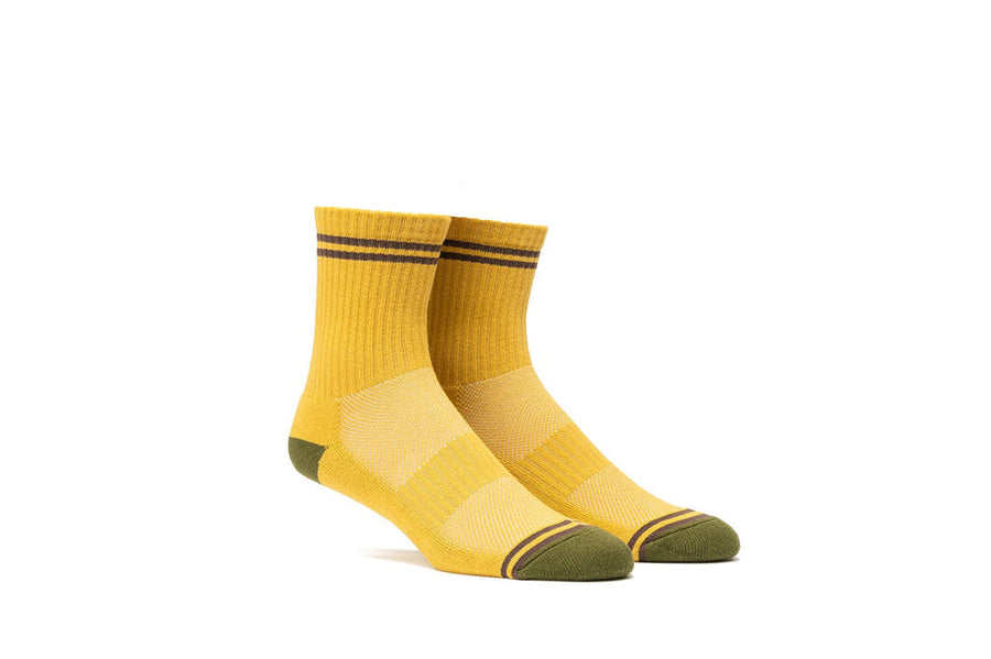 Mustard yellow crew socks with olive heel and toe, quarter view
