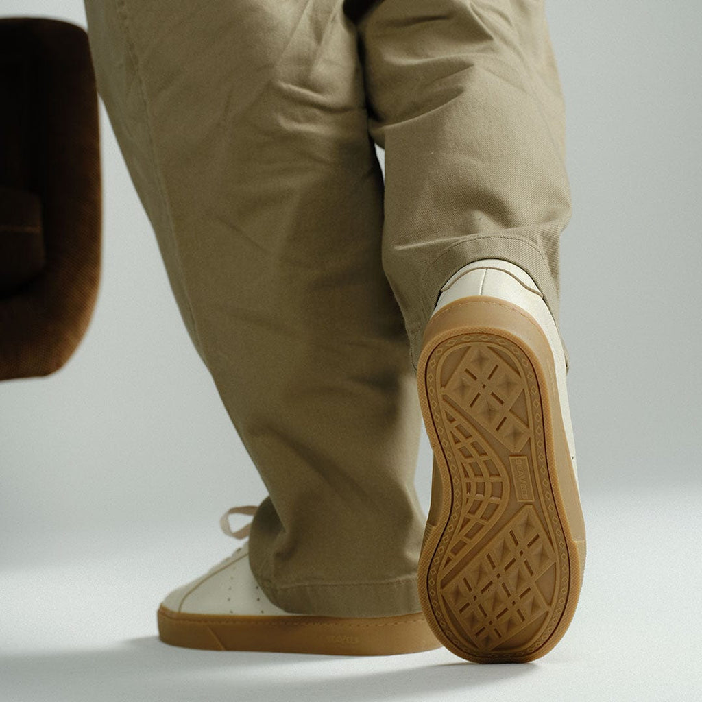 Men's Diamond Cup sneaker in Black leather, ecru pair worn with khaki pants, heel view