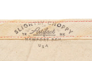 Close up of the Slightly Choppy Artifact label on cream fabric