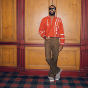 Men's Hawthorne Slip On in Pavement suede, worn with brown pants by a person standing in a paneled room