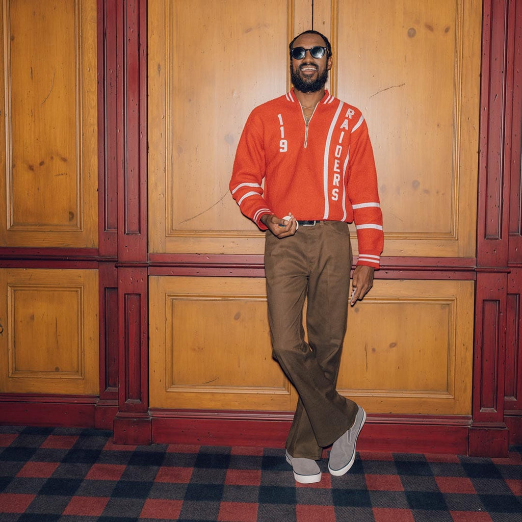 Men's Hawthorne Slip On in Pavement suede, worn with brown pants by a person standing in a paneled room