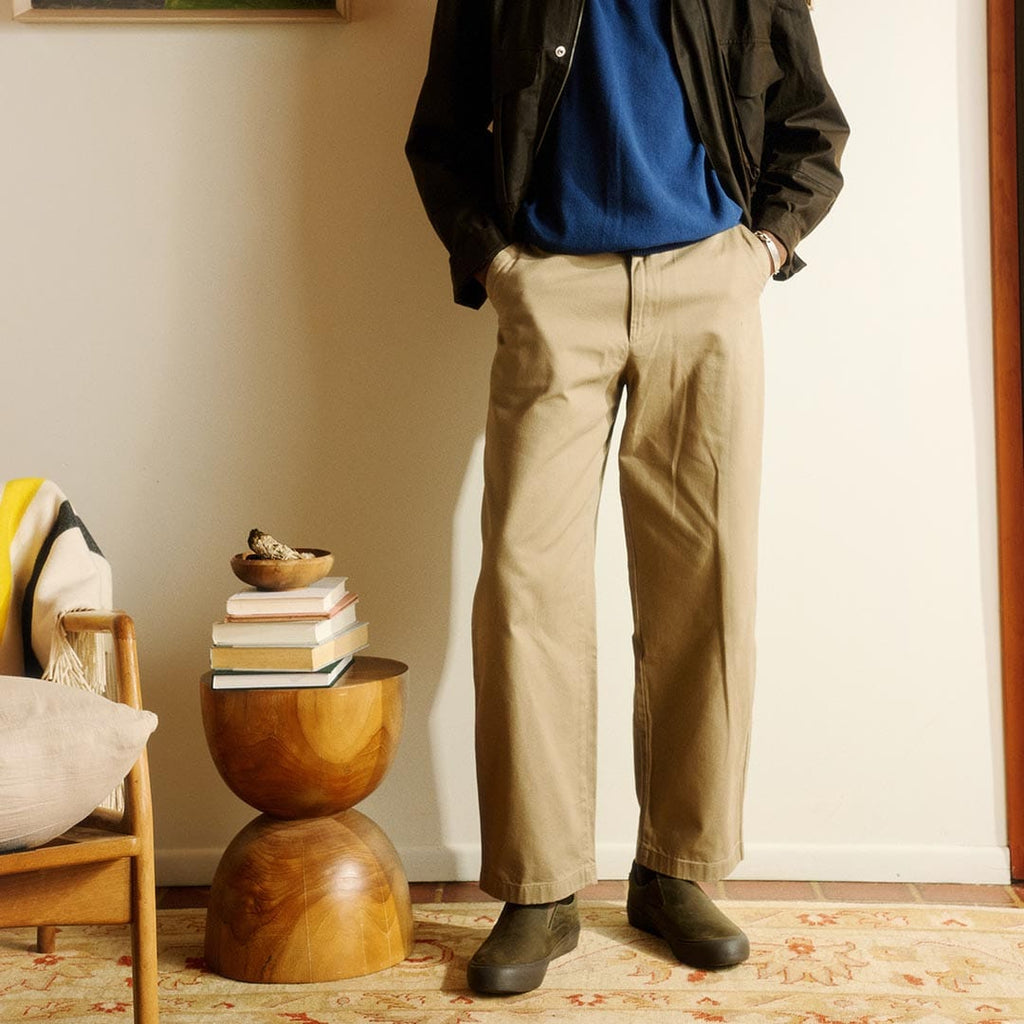 Men's Hawthorne Slip On in Black Olive leather, worn by a person standing in khaki pants and a dark jacket