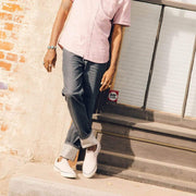 Men's Hawthorne Slip On in Ecru suede, worn with cuffed jeans by a person standing at a doorstep