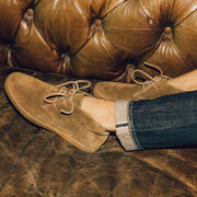 Men's Sun-tans Chukka in Desert Palm suede, close-up worn on a tufted leather sofa