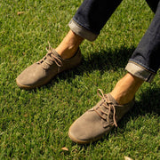 Men's Sun-tans Buck in Fossil suede, close-up worn with cuffed jeans on grass