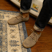 Men's Sun-tans Buck in Fossil suede, close-up worn with dark jeans on a patterned rug