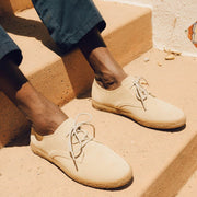 Men's Sun-tans Buck in Sandstone suede, close-up worn on sandy-colored steps