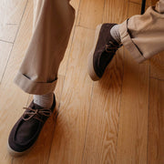 Men's Hayward Loafer in Chocolate suede, worn with khaki pants on a light wood floor