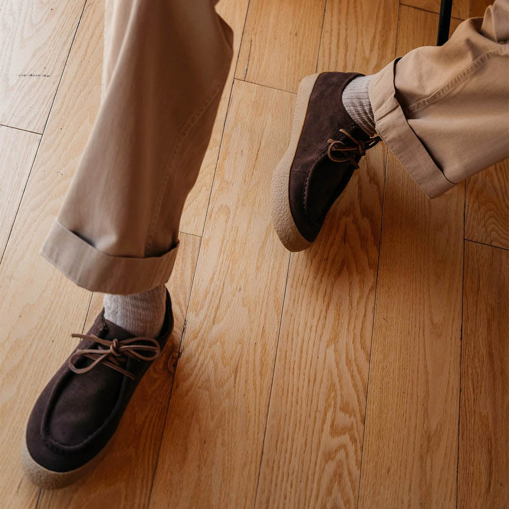Men's Hayward Loafer in Chocolate suede, worn with khaki pants on a light wood floor