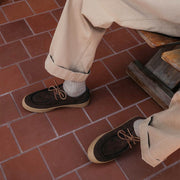 Men's Hayward Loafer in Chocolate suede, worn with rolled khaki pants on a red tile floor