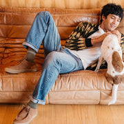 Men's Hayward Loafer in Tobacco suede, worn by a person lounging on a leather sofa with a dog