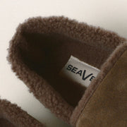 Men's Lodge Slipper in Woodsmoke suede, close up of the interior shearling lining and branded label