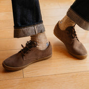 Men's Sun-tans Buck in Fossil suede, close-up worn with cuffed jeans and wool socks on a wood floor