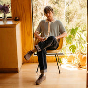 Men's Sun-tans Buck in Fossil suede, worn with dark jeans by a person seated in a sunlit room