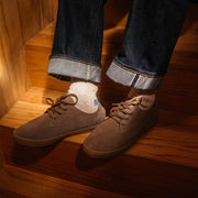 Men's Sun-tans Buck in Fossil suede, close-up worn with cuffed jeans on wooden stairs