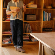 Men's Sun-tans Buck in Fossil suede, worn with dark jeans by a person standing at a bookshelf
