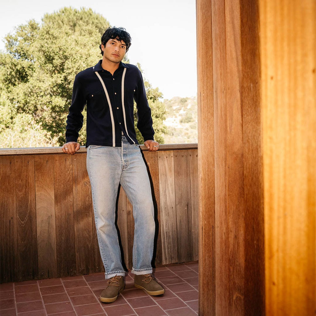 Men's Sun-tans Chukka in Desert Palm suede, worn with light jeans, full-length view on a wooden deck