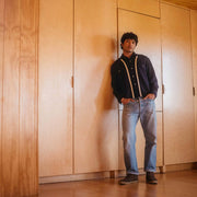 Men's Sun-tans Chukka in Desert Palm suede, worn with light jeans, full-length view in front of wood cabinets