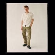 Men's Tahoe Trekker sandal in Black leather, worn by a person standing in olive pants and a white shirt