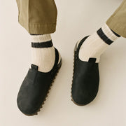 Men's Tahoe Trekker sandal in Black leather, worn with striped cream socks, close up