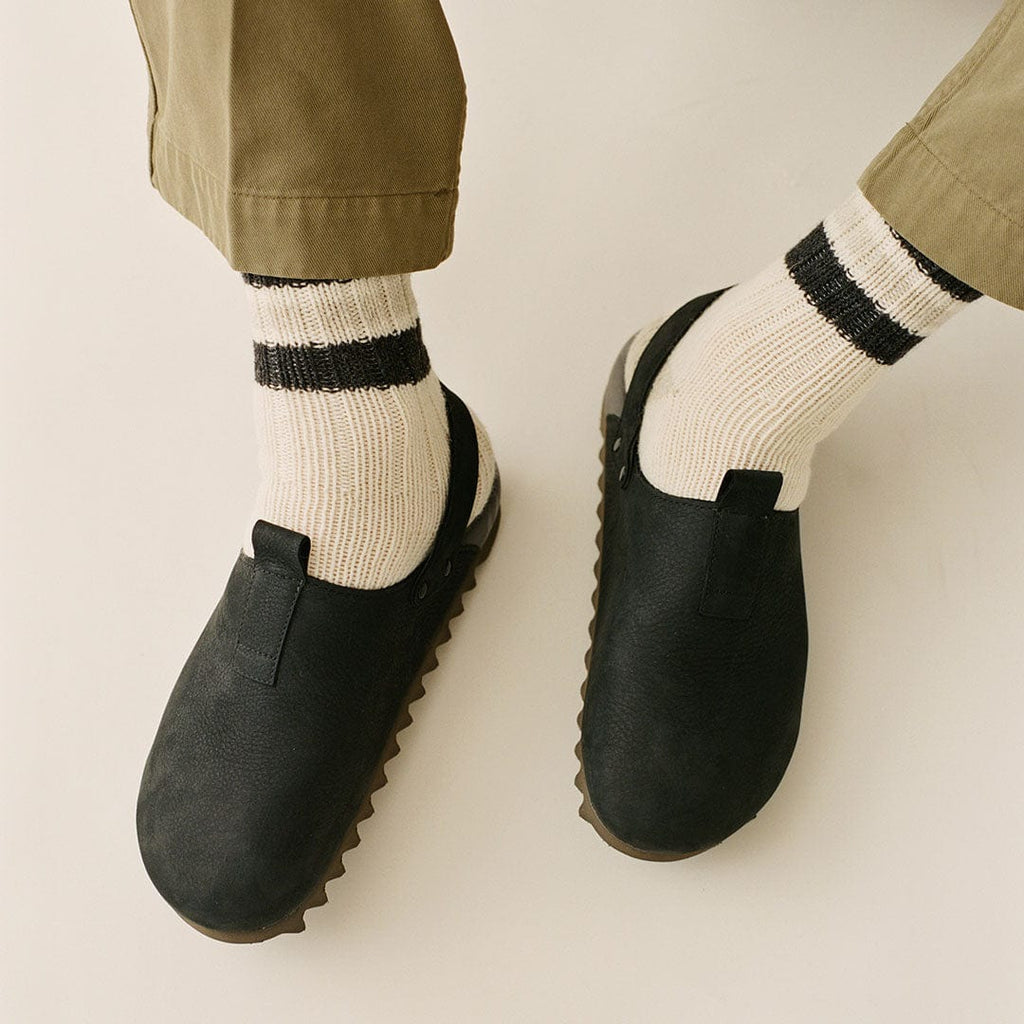 Men's Tahoe Trekker sandal in Black leather, worn with striped cream socks, close up