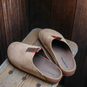 Men's Tiburon Trekker sandal in Maple suede, pair resting on a wooden bench