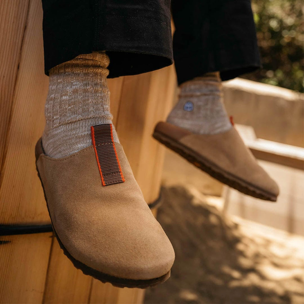 Men's Tiburon Trekker sandal in Maple suede, worn on a wood floor with gray socks, close up