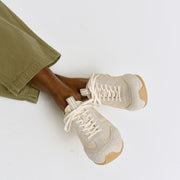 Men's Wilcox Low Profile Trainer sneaker in Cloud nylon and suede, worn with olive pants, seated, top view
