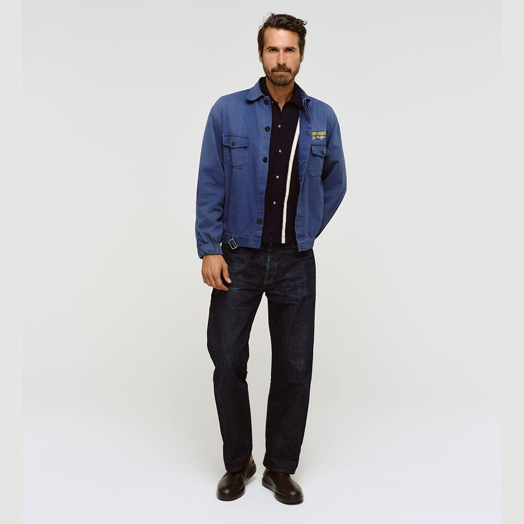 Men's Williams Mule in Dark Chocolate rubber, worn by a person standing in a blue jacket and dark jeans