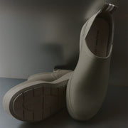 Women's Calistoga Clog in Concrete rubber, pair on a dark surface, showing the outsole