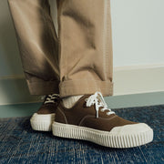 Men's Sato Oxford in Brownstone canvas, worn with khaki pants on a blue rug, front view