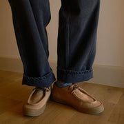 Men's Hayward Loafer in Tan suede, worn with cuffed dark jeans on a wood floor
