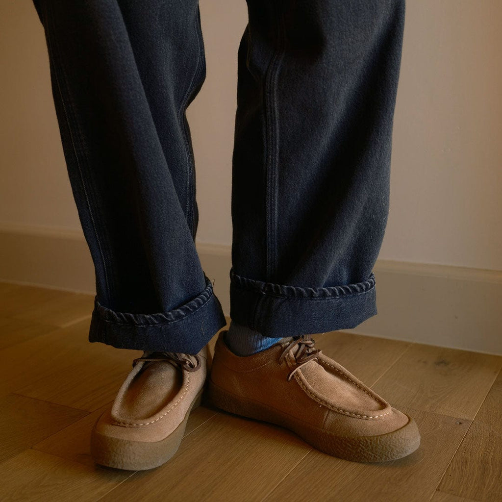 Men's Hayward Loafer in Tan suede, worn with cuffed dark jeans on a wood floor