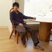 Men's Sun-tans Buck in Timber leather, worn by a man seated at a round table
