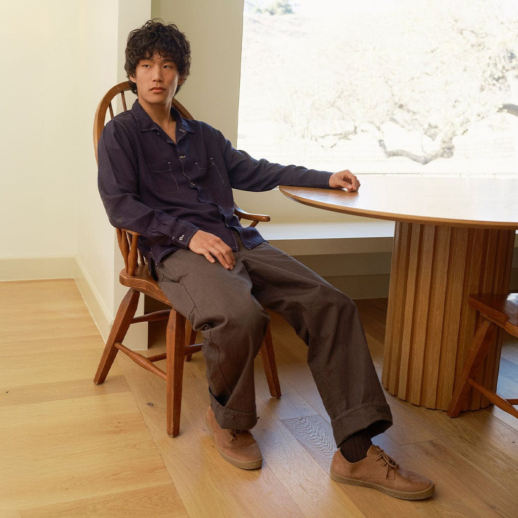 Men's Sun-tans Buck in Timber leather, worn by a man seated at a round table