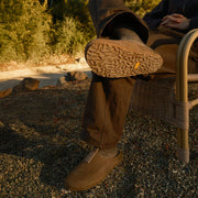 Men's Tiburon Trekker sandal in Fossil leather, worn with brown pants outdoors, sole visible