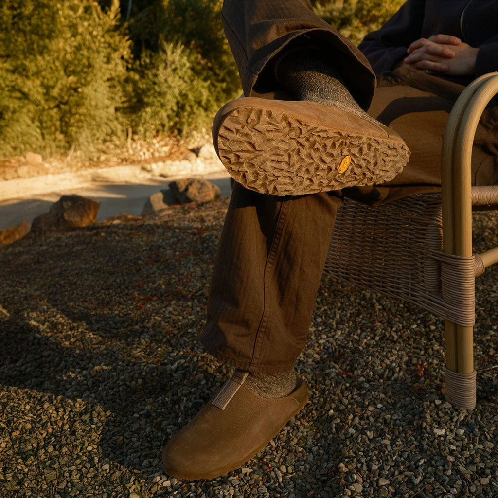 Men's Tiburon Trekker sandal in Fossil leather, worn with brown pants outdoors, sole visible