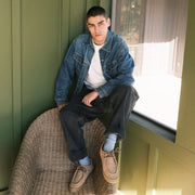 Men's Hayward Loafer in Tan suede, worn by a person seated on a wicker chair in a denim jacket