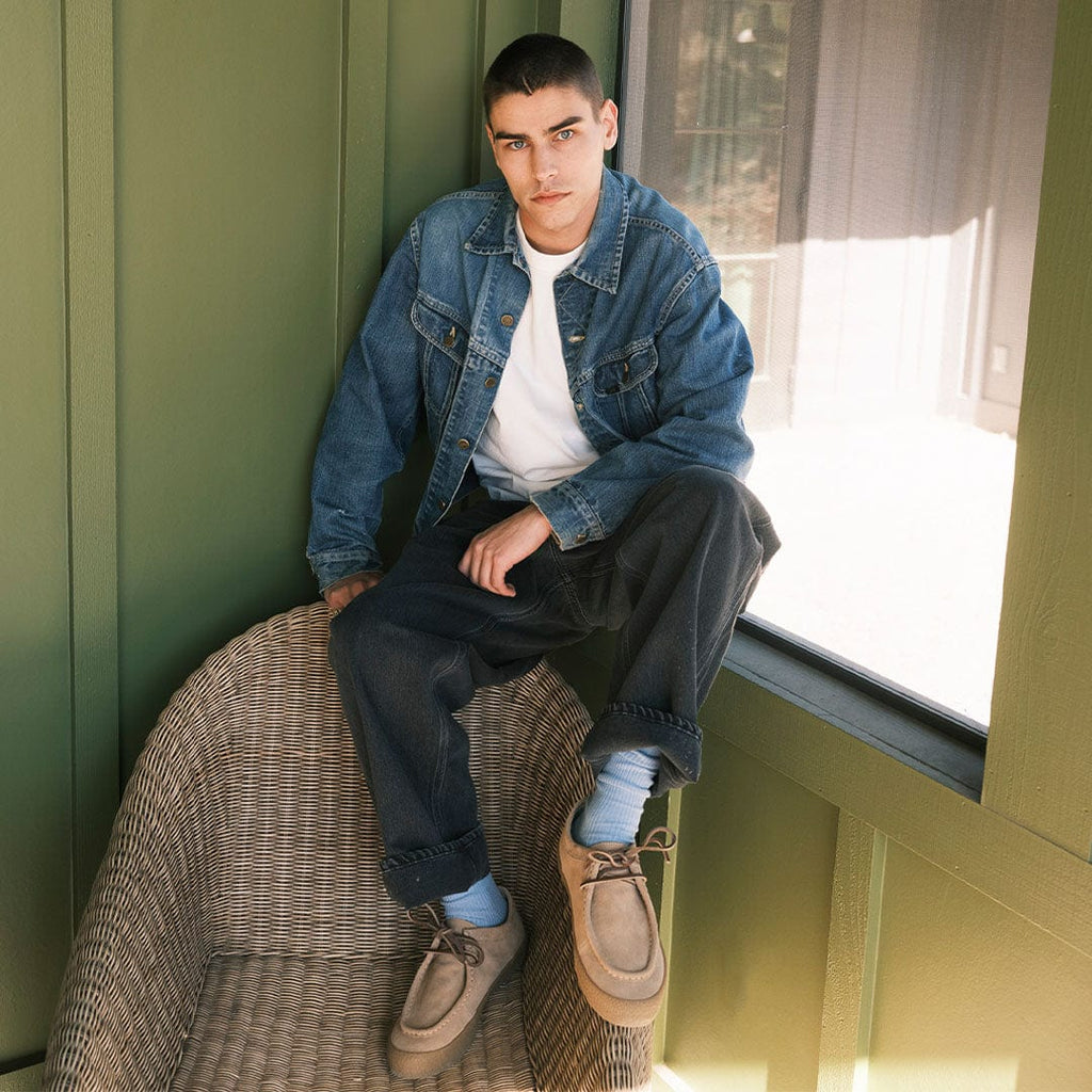 Men's Hayward Loafer in Tan suede, worn by a person seated on a wicker chair in a denim jacket