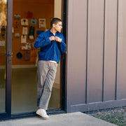 Men's La Brea Lug in White canvas, worn by a person standing in a doorway in a blue jacket