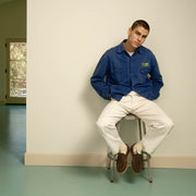 Men's Carmel Loafer in Dark Chocolate suede, worn by a person seated on a stool in a denim jacket