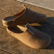 Men's Tiburon Trekker sandal in Fossil leather, pair on a sunlit wood surface, angled view