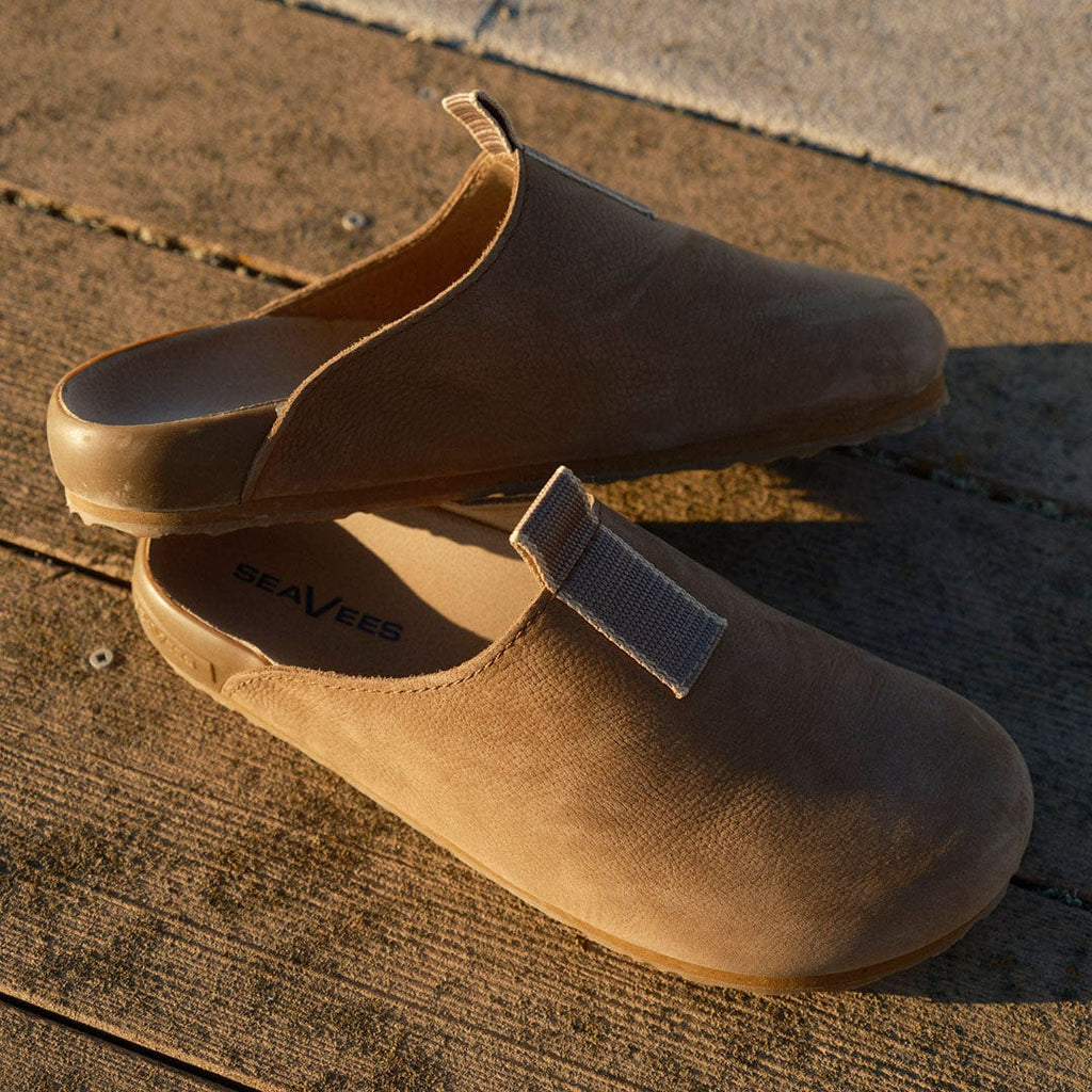 Men's Tiburon Trekker sandal in Fossil leather, pair on a sunlit wood surface, angled view