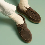 Men's Carmel Loafer in Dark Chocolate suede, worn with white socks and cream pants, close up
