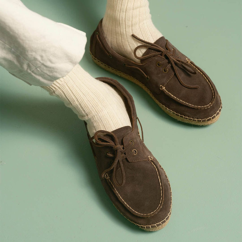 Men's Carmel Loafer in Dark Chocolate suede, worn with white socks and cream pants, close up