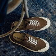 Men's Sato Oxford in Brownstone canvas, pair with white laces on a blue rug, top view