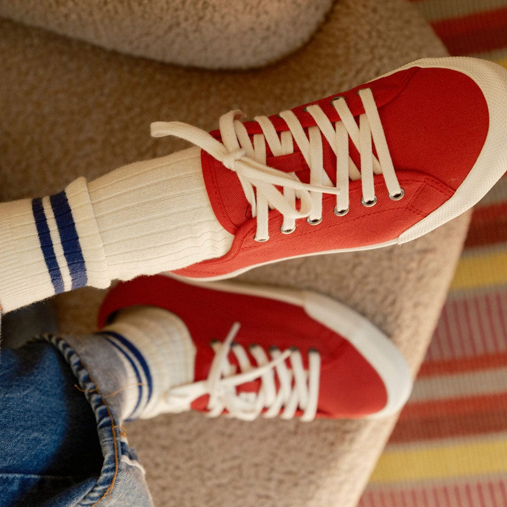 Women's Monterey Sneaker in Forever Red canvas, close-up worn with striped socks and white laces