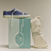 Men's Founders Edition Yacht Shoe in Navy canvas, pair resting on a mint green shoe box beside a cotton drawstring bag