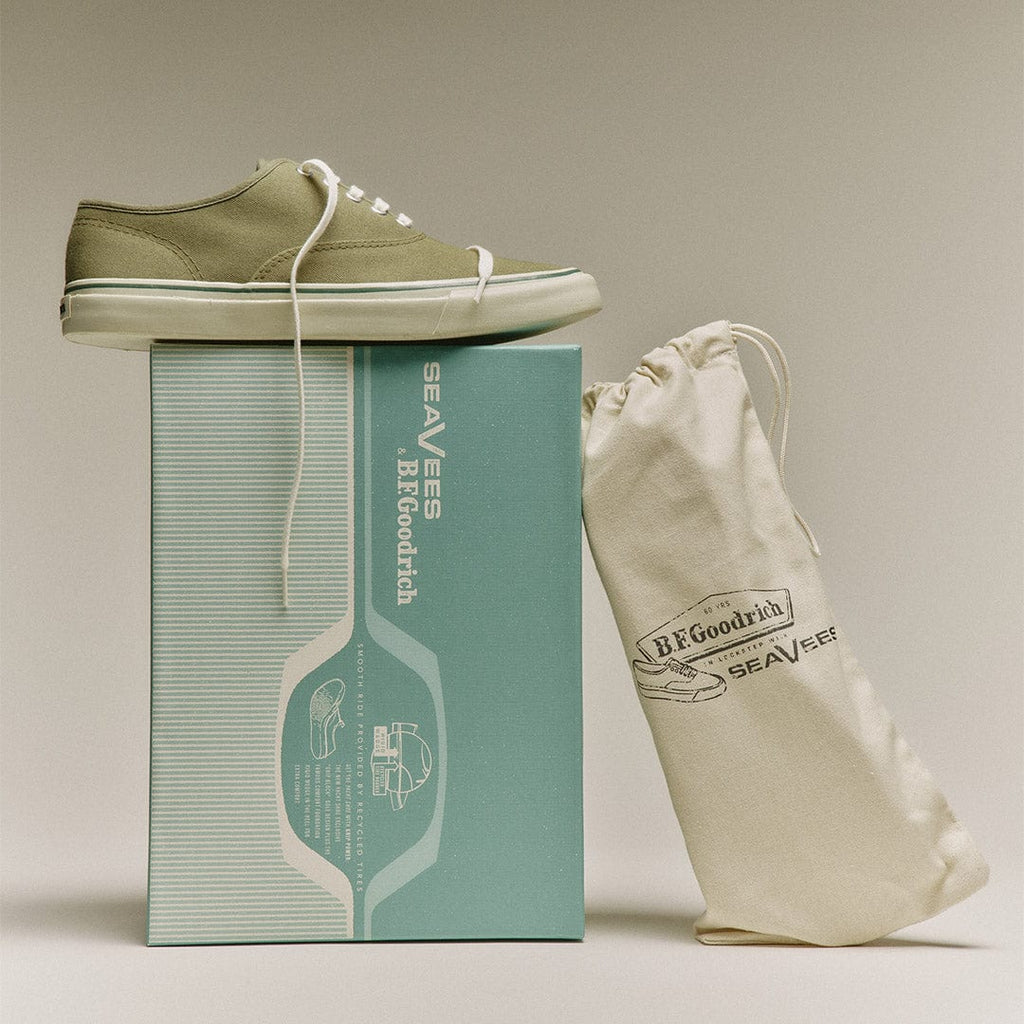 Men's Founders Edition Yacht Shoe in Green canvas, pair resting on a mint green shoe box beside a cotton drawstring bag